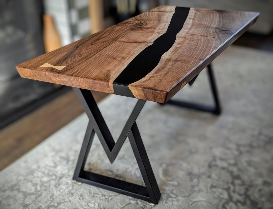 Small-scale epoxy river table with natural wood and translucent blue resin showcasing modern furniture design