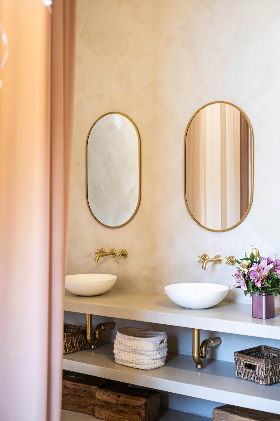 Luxury bathroom with seamless microcement finish and brushed brass fittings