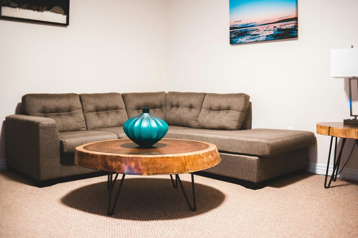 Live-edge round coffee table with hairpin legs in a residential living room